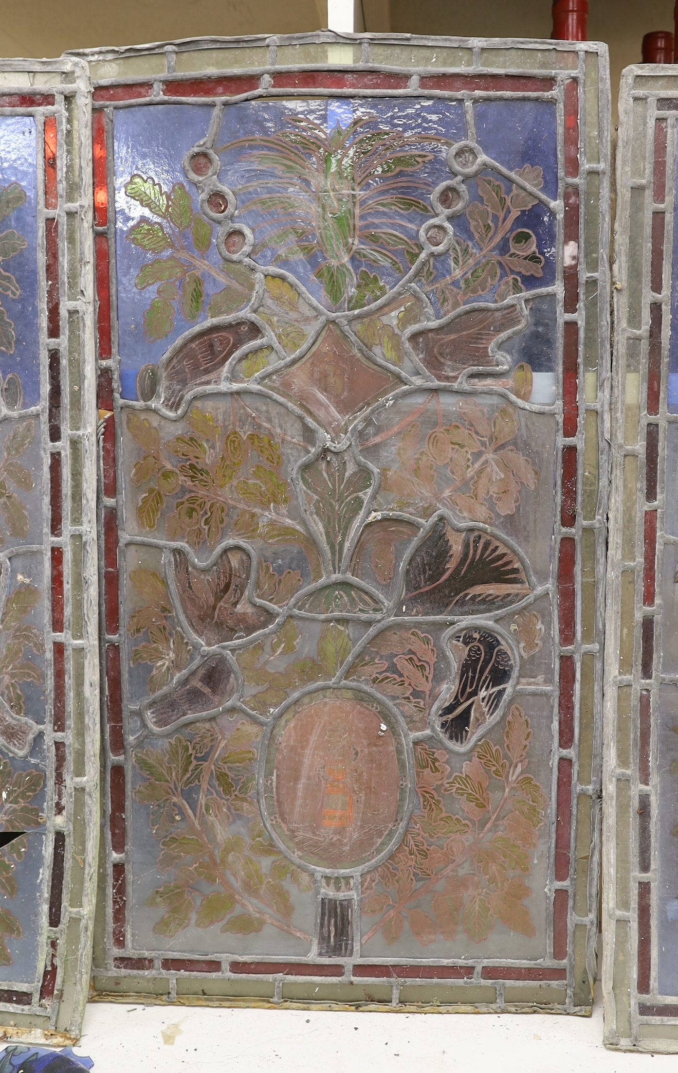 Three stained glass panels of birds and foliage, 71cm high, 39cm wide (a.f.)